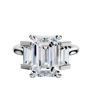 The Platinum 3-Stone Baguette Side Stones Set North/South 0.25TCW Engagement Ring features a central diamond flanked by two baguette side stones, displayed against a plain white background.