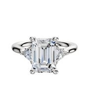 An 18K white gold engagement ring featuring a large center stone and two trillion side diamonds (0.125TCW), displayed on a plain white background.