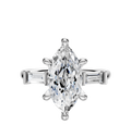 An 18K white gold engagement ring with a marquise-cut center and 0.125TCW baguette east/west side stones, displayed on a plain light background.