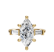 The 18K Yellow Gold 3-Stone Baguette East/West Side Stones 0.125TCW Engagement Ring features a striking center stone with rectangular baguette-cut diamonds on either side, beautifully showcased against a plain white background.