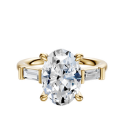 The 18K Yellow Gold 3-Stone Baguette East/West Side Stones 0.125TCW Engagement Ring features a central diamond with two rectangular baguette side stones, shown on a simple white background.