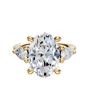The 14K Yellow Gold 3-Stone Pear Side Stones 0.25TCW Engagement Ring features a central oval diamond with two pear-shaped side stones, all set in yellow gold and showcased on a plain white background.