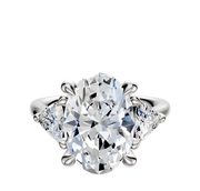The Platinum 3-Stone Trillion Side Stones 0.25TCW Engagement Ring features a central oval-cut diamond with two triangular side diamonds, all set in platinum against a plain white background.