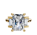 The 14K Yellow Gold 3-Stone Baguette Side Stones Set North/South 0.25TCW Engagement Ring features a large central rectangular stone with two smaller baguette side stones in prong settings for a classic, elegant look.