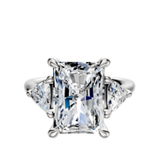 The Platinum 3-Stone Trillion Side Stones 0.25TCW Engagement Ring showcases a radiant-cut center diamond with two triangular side stones, all set in platinum against a white background.