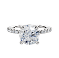 The 14K White Gold 4 Prong Basket Classic Dome 1-Row-Pave 2.5mm Engagement Ring features a round center stone held by four prongs and a band adorned with a row of sparkling pave-set diamonds.