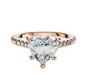The 14K Rose Gold 4 Prong Hidden Halo Cathedral Dome 1-Row-Pave 2.5mm Engagement Ring features a striking center stone and round accent diamonds along the band for added sparkle.