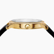 The 41MM Swiss Made 18K Yellow Gold Signature Panther Watch features a diamond bezel, black leather strap, and jeweled panther dial with black spots, green eyes, and a blue-and-gold accented subdial.