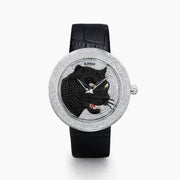 The 39MM Swiss Made Stainless Steel Signature Panther Watch with Diamonds features a black leather strap, diamond-encrusted bezel, and a dial adorned with a detailed panther head crafted from black and colored gemstones.