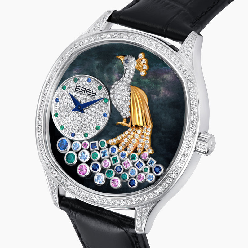 The 41MM Swiss Made Stainless Steel Peacock Watch features diamonds, sapphires, a black leather strap, and a jeweled peacock design with multicolored gemstones and a small round time display on the left side.
