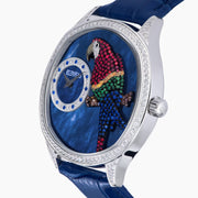 The 41MM Swiss Made Stainless Steel Parrot Watch features a jeweled parrot dial, diamond accents, blue leather strap, and elegant case with emeralds and sapphires—an exquisite statement of luxury and craftsmanship.