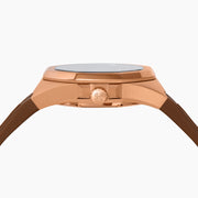 The 42MM Swiss Made 18K Rose Gold Signature Panther Automatic Watch features a brown rubber strap, brown dial with a geometric panther face, diamond markers, green gemstone eyes, and the EARLY name for timeless elegance.
