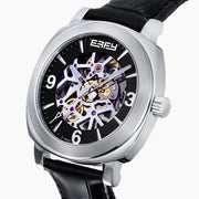 The 41MM Swiss Made Stainless Steel and Leather Automatic Skeleton Watch features a black leather strap, silver case, black skeleton dial, and white hour markers with numerals at 3, 6, and 9 to showcase Swiss precision craftsmanship.
