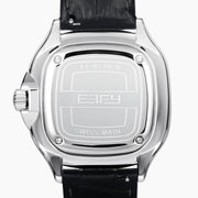 The 39MM Swiss Made Stainless Steel Watch with Diamonds and Black Spinel features a black leather strap, diamond-studded bezel, silver textured dial with blue accents, and bold black hands, shown on a white background.