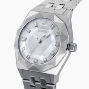 A Swiss made timepiece, the 36MM Titanium Watch with Diamonds showcases a silver geometric metal band and a faceted bezel, complemented by a light blue mother-of-pearl dial accented with diamond hour markers.