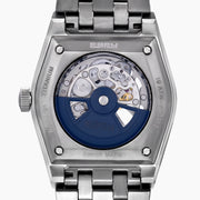 A 42MM Swiss made titanium automatic skeleton watch featuring a geometric bezel that reveals intricate gears and movements beneath the dial, complemented by a metal link bracelet.
