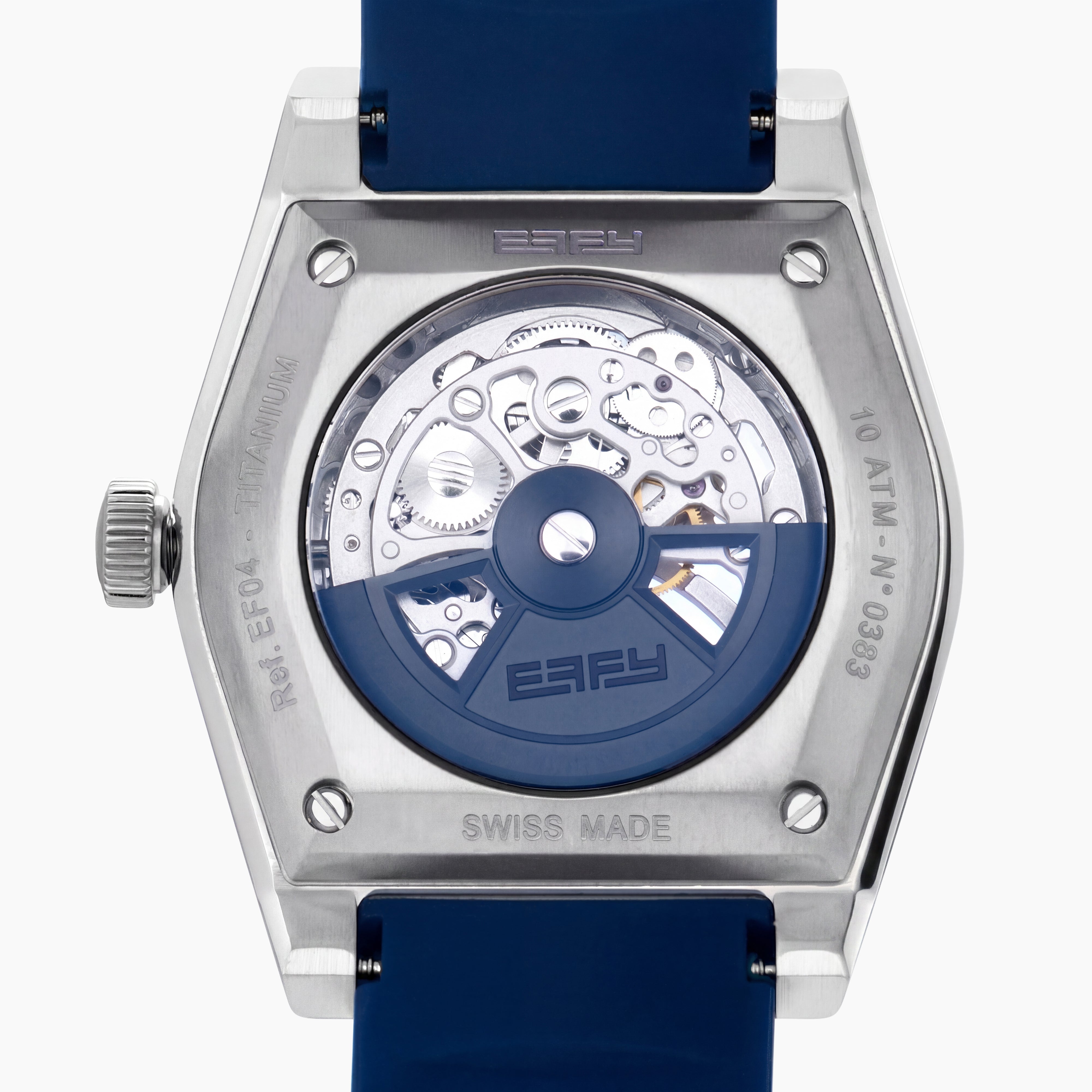 Introducing the 42MM Swiss Made Titanium and Silicone Automatic Skeleton Watch—a luxurious timepiece featuring a geometric silver titanium case and exposed inner mechanisms. Accented with a blue bezel and paired with a blue silicone strap, this design stands out against a white backdrop. Its exceptional clarity and elegance are enhanced by a diamond-cut sapphire crystal.