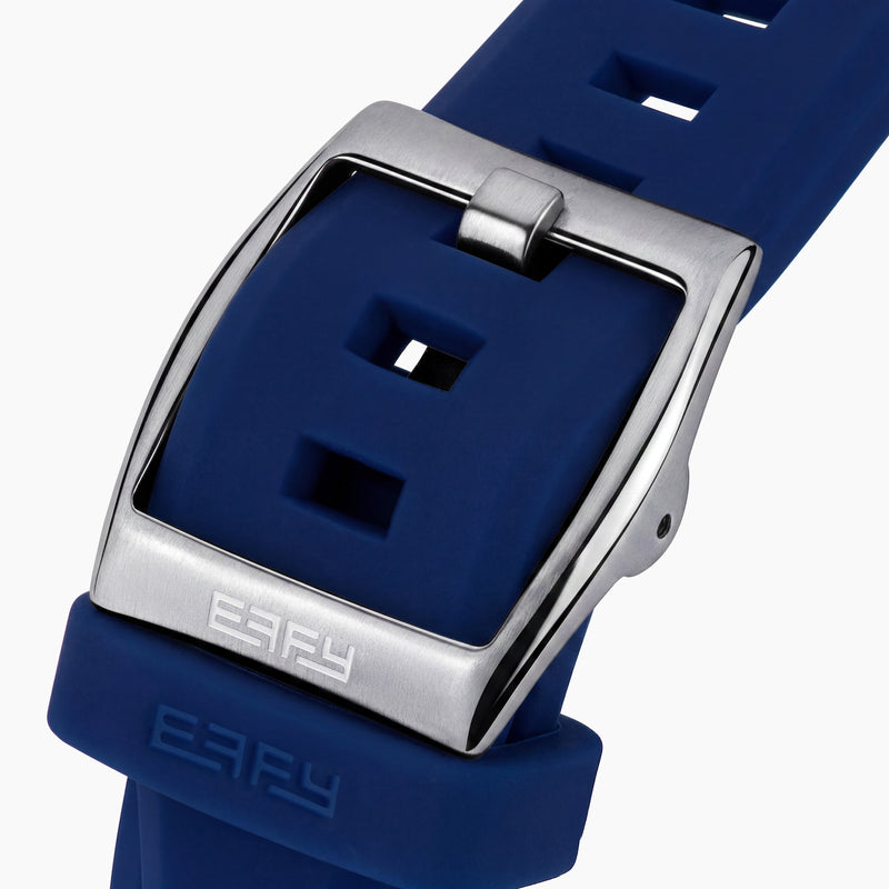 Introducing the 42MM Swiss Made Titanium and Silicone Automatic Skeleton Watch—a luxurious timepiece featuring a geometric silver titanium case and exposed inner mechanisms. Accented with a blue bezel and paired with a blue silicone strap, this design stands out against a white backdrop. Its exceptional clarity and elegance are enhanced by a diamond-cut sapphire crystal.