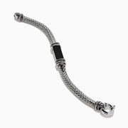 The Men's 925 Sterling Silver Braided Chain Onyx Bracelet 5.0 TCW features a braided silver band with a rectangular black onyx centerpiece, decorative metal accents, and a round clasp, shown on a white background.