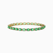 A 14K yellow gold tennis bracelet featuring oval emeralds and diamonds, totaling 9.56 TCW, displayed on a white background.