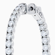 The 14K White Gold Inside Out Diamond Hoop Earrings (2.00 TCW) are shown vertically on a plain white background, with their shadows cast to the side.