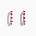 The 14K White Gold Ruby & Diamond Hoop Earrings, 1.35 TCW, feature alternating round red rubies and clear diamonds set in gleaming white gold, shown against a white background.