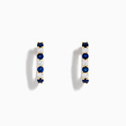 The 14K Yellow Gold Blue Sapphire & Diamond Hoop Earrings, 1.10 TCW, feature alternating sapphires and diamonds in a classic hoop design, shown on a plain white background with visible shadows.