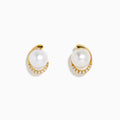 14K Yellow Gold Cultured Pearl and Diamond Stud Earrings featuring round cultured pearls at the center and a curved row of sparkling diamonds on one side, shown against a plain white background.