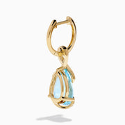 Ocean Bleu 14K Yellow Gold Blue Topaz and Diamond Pear Dangle Earrings feature teardrop-shaped blue topaz gemstones accented with a curved line of sparkling diamonds.