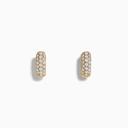 A pair of 14k Yellow Gold Diamond Huggie Earrings, each adorned with rows of sparkling diamonds, showcased against a plain white background.