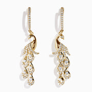 The 14K Yellow Gold Diamond Peacock Drop Earrings feature a peacock design with sparkling diamonds on the head, body, and tail feathers for a luxurious and elegant style.