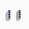 The Royale Bleu 14K White Gold Sapphire & Diamond Hoop Earrings, 1.03 TCW, showcase rows of sapphires bordered by diamond accents, elegantly displayed against a white background.
