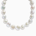 A close-up of the 14K Yellow Gold Freshwater Coin Shape Pearl Necklace, showcasing round, iridescent pearls in a partial semicircle on a white background.
