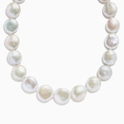 A close-up of the 14K Yellow Gold Freshwater Coin Shape Pearl Necklace, showcasing round, iridescent pearls in a partial semicircle on a white background.