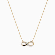 14K Yellow Gold Diamond Accented Infinity Necklace featuring an infinity symbol pendant with diamond accents, displayed against a white background.