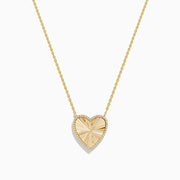 The 14K Gold Malachite and Diamond Reversible Heart Necklace showcases a large, heart-shaped malachite pendant with a smooth finish and delicate gold border.