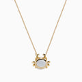 The Seaside 14K Yellow Gold Mother Of Pearl and Diamond Crab Necklace features a white oval mother of pearl center, shimmering diamond accents, and a charming crab pendant on a delicate yellow gold chain.