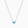 The Lab Grown Blue Diamond Necklace in 14K White Gold features a rectangular emerald-cut lab-grown blue diamond pendant in a simple bezel setting on a delicate white gold chain.
