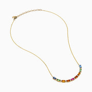 The Watercolors 14K Yellow Gold Multi Sapphire and Diamond Necklace features a delicate gold chain with a gradient row of rectangular multicolored sapphires and diamond accents, displayed on a white background.