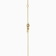 The 14K Yellow Gold Blue and White Diamond Halo Pendant features a round blue gemstone centerpiece surrounded by sparkling white diamonds, all set on a delicate fine chain.