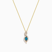 The 14K Yellow Gold Blue and White Diamond S-Curve Halo Pendant features a marquise-shaped blue and white diamond with small white stones in a symmetrical halo on a gold chain necklace.
