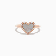 The 14K Rose Gold Mother of Pearl and Diamond Heart Ring features a heart-shaped mother-of-pearl centerpiece framed by sparkling diamonds.