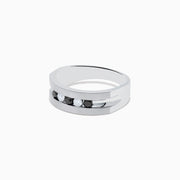 The Mens Sterling Silver Black and White Diamond Ring, 0.50 TCW, features a flat band with alternating black and white diamonds set in a striking central row.