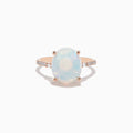 The Aurora 14K Rose Gold Opal and Diamond Ring features an oval iridescent opal center, accented by small round diamonds on the band, displayed against a white background.