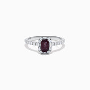 The Effy Hematian 14K White Gold Ring features a cushion-cut alexandrite center stone, surrounded by a diamond halo and additional diamonds set along the band.