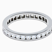 The 14K White Gold Channel Set Diamond Eternity Band, 1.00 TCW, showcases a seamless row of round diamonds in a channel setting for elegant sparkle against polished white gold.