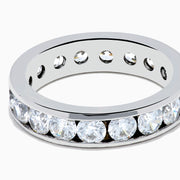 The 14K White Gold Channel Set Diamond Eternity Band, 3.00 TCW, features large round-cut diamonds evenly channel set around the ring and is shown on a plain white background.