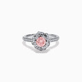 The Lab Grown Pink and White Diamond Rose Ring in 14K White Gold features a round pink center stone, a floral halo of lab grown diamonds, and additional diamonds along the band.