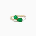 The Brasilica 14K Yellow Gold Emerald and Diamond Bypass Ring features two pear-shaped green emeralds set opposite each other on a curved band accented with sparkling diamonds.