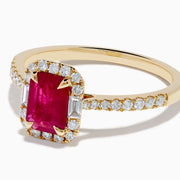The Ruby Royale 14K Yellow Gold Ruby and Diamond Halo Ring features a rectangular ruby center, surrounded by a halo of round and baguette diamonds, with extra diamond accents on the band for added brilliance.